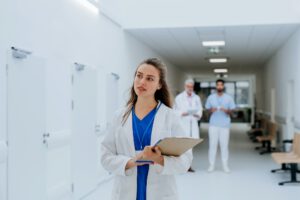 Portrait of young woman doctor at hospital corridor.